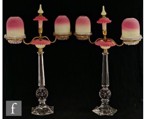 A pair of 19th Century Clarke's Cricklite two arm candelabra, each with a pressed glass candle holder with a Thomas Webb Quee