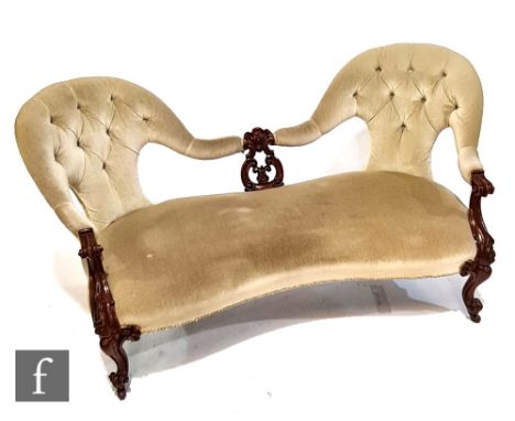 A Victorian twin-ended spoon-back settee, with pierced central splat and with carved scroll capitals, height 80cm, width 163c