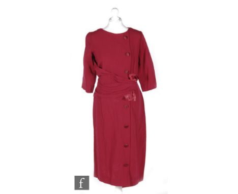 A 1940s/50s ladies vintage dress in maroon/burgundy heavy crepe with sash and satin bow detail over a vertical panel of butto