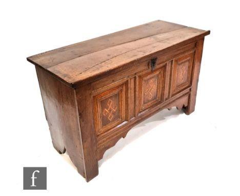 An 18th Century light oak coffer, the hinged top over an inlaid and triple panelled front on stiles, height 67cm x depth 48cm