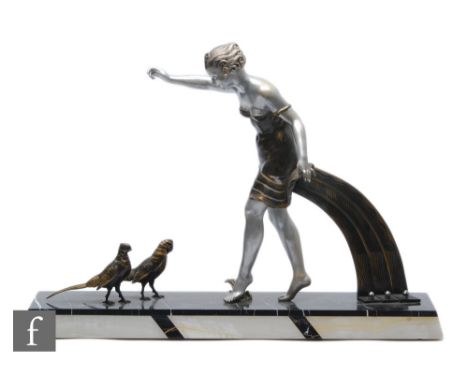 An early 20th Century Art Deco spelter study, depicting a silvered and gilt decorated female figure with two stylised pheasan