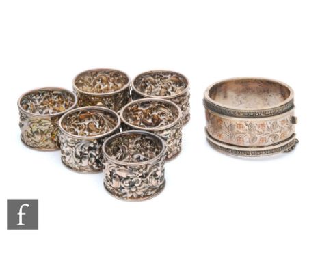 A set of six hallmarked silver circular napkin rings each with foliate embossed decoration, Chester 1907, with an unmarked si