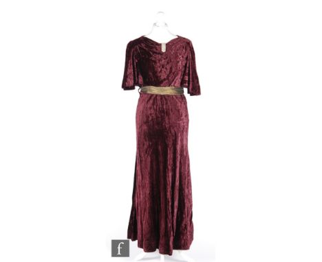 A 1920s/30s ladies vintage evening dress in deep purple velvet, with high neck and diamante clip decoration, wide batwing sho