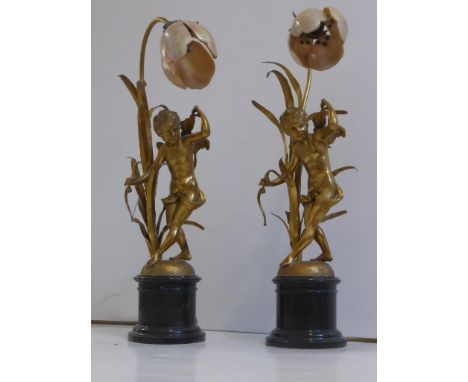 PR. GOOD QUALITY FRENCH GILT METAL TABLE LAMPS, EACH CAST IN THE FORM OF A CHERUB WITH BOW, RAISED ON A TURNED ONYX BASE AND 