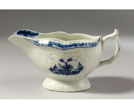 A SMALL SIZED WORCESTER BLUE AND WHITE  SAUCEBOAT, with slightly curved vertical moulding painted with two slightly differing