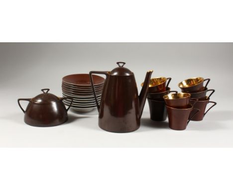 A LIMOGES PORCELAIN PART COFFEE SERVICE, brown glazed, comprising coffee pot, sucrier, eight cups and saucers.