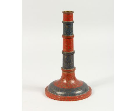 AN ISLAMIC ENAMEL DECORATED CANDLESTICK. 9ins high.
