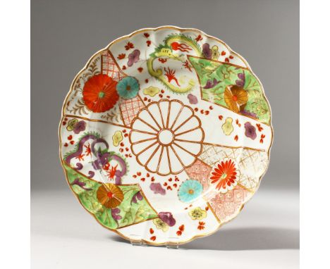 A WORCESTER COLOURED PLATE, painted with dragons, flowering prunus and chrysanthemums, rare gold crescent mark.