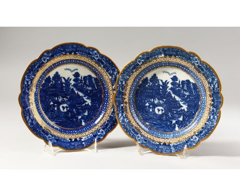 A PAIR OF CAUGHLEY BLUE AND WHITE PLATES, decorated with a complex Oriental landscape with an internal peacock's eye border a