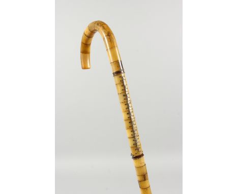 AN UNUSUAL SEGMENTED BONE WALKING STICK. 2ft 10ins long.