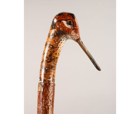 A WALKING STICK, with carved and painted pheasant head handle. 49ins long.