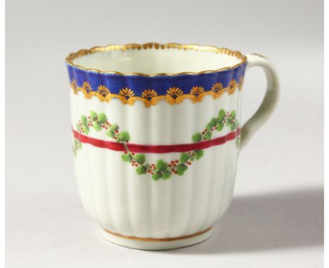 A WORCESTER REEDED COLOURED COFFEE CUP, with blue and gilt border, having a red line entwined with swags of holly berries, no