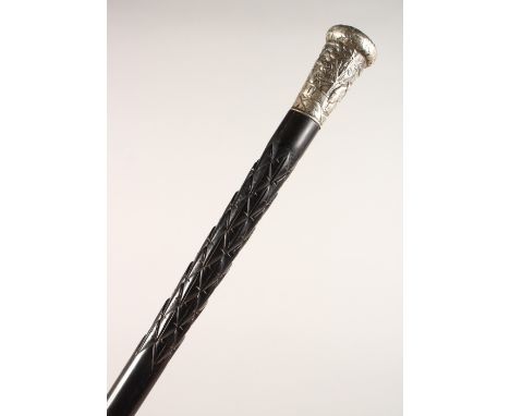 A CARVED EBONY WALKING STICK, with embossed Chinese white metal top. 34ins long.