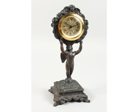 A BRONZED SPELTER CLOCK on a stand. 9.5ins high.