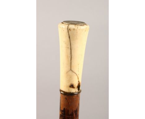 AN IVORY HANDLED WALKING STICK. 35ins long.