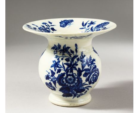 A RARE WORCESTER BLUE AND WHITE SPITTOON, decorated with scattered flowering plants and a butterfly, crescent mark.