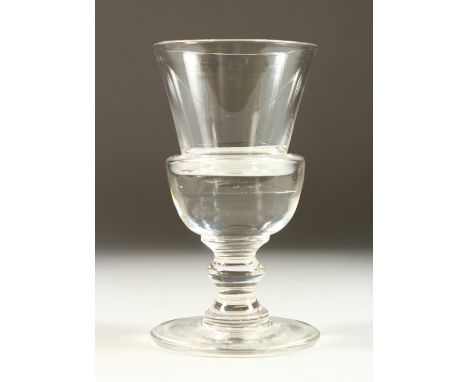 A GOOD TRUMPET SHAPED PLAIN GLASS on a large circular base. 7ins high.