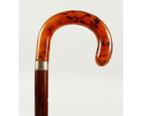 A WALKING STICK with faux-tortoiseshell handle and silver band. Birmingham. 2ft 1in long.