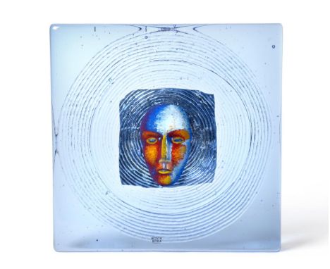Bertil Vallien (Swedish, 1938-) for Kosta Boda: A Headman Tile, painted head encased in blue glass, signed KOSTA BODA B Valli