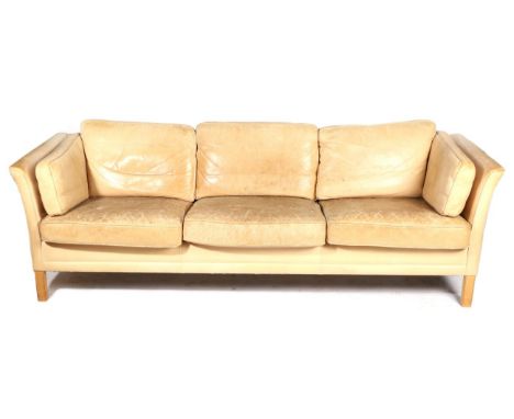 A Danish Leather Two-Seater Sofa, with arched back and curved arms, on stained mahogany square form legs, 155cm by 80cm by 61