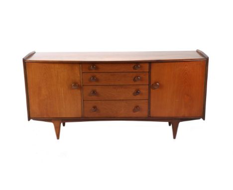 A Younger Ltd: A 1970s Eight Piece Teak Dining Suite, comprising a bowfront sideboard with four central graduated drawers fla