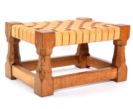 Mouseman: A Robert Thompson English Oak Footstool, with interwoven leather top, on four octagonal legs, with carved mouse sig