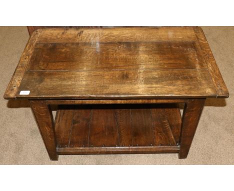 An Oak Plank Top Coffee Table, modern, with cleated ends, on tapering legs joined by a shelf, 91cm by 51cm by 57cm