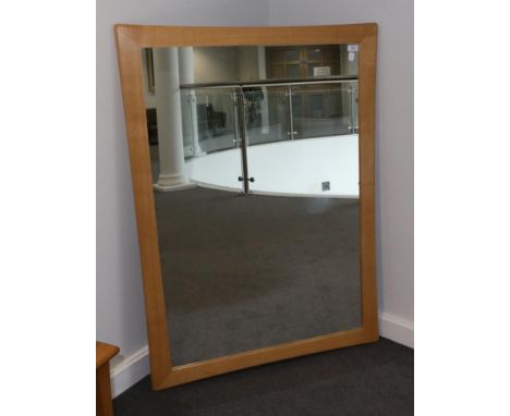 An Ercol Light Oak Wall Mirror, with plain mirror plate, 129cm by 90cm
