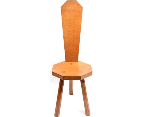 Mouseman: A Robert Thompson English Oak Spinning Chair, with shaped back, heptagonal seat, on three octagonal legs, with carv