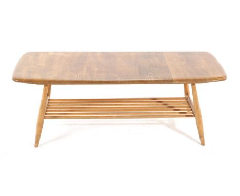 Ercol: A 1970/80s Originals Ash Coffee Table, of rounded rectangular form with spindle form shelf, 104cm by 46cm by 36cm labe