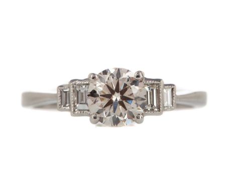 DIAMOND DRESS RING,the round brilliant cut diamond of approximately 0.90 carats, flanked by baguette cut diamonds totalling a