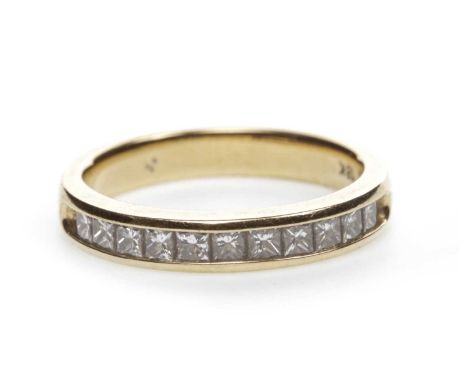 DIAMOND HALF ETERNITY RING,with a row of channel set princess cut diamonds totalling approximately 0.50 carats, in eighteen c