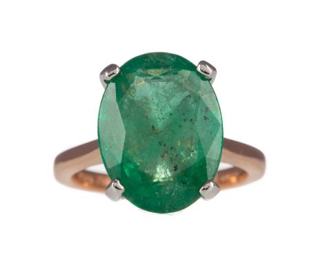 EMERALD RING,set with an oval emerald of approximately 6.62 carats, in eighteen carat rose gold and platinum, size L 1/2, 6.5