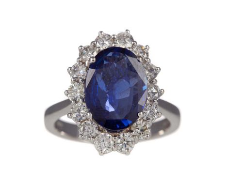 SAPPHIRE AND DIAMOND RING,the oval sapphire of approximately 4.02 carats, within a halo of round brilliant cut diamonds, in e