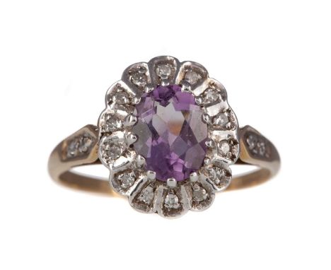 AMETHYST AND DIAMOND CLUSTER RING,the central oval amethyst within an illusion set halo of round brilliant cut diamonds, in n