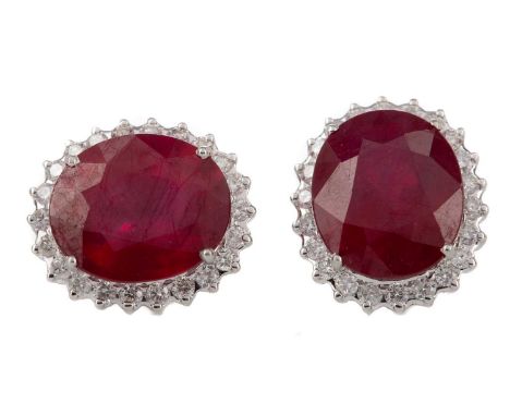 PAIR OF GLASS FILLED RUBY AND DIAMOND EARRINGS,the oval faceted rubies within a halo of round brilliant cut diamonds totallin