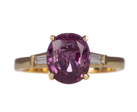 PINK SAPPHIRE AND DIAMOND RING,the oval sapphire of approximately 1.40 carats, flanked by tapered baguette cut diamonds, mark