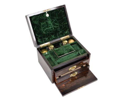 A Victorian Coromandel dressing box. The hinged case has brass fretwork mounts, mother of pearl escutcheon and mother of pear