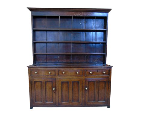 George III oak dresser, top section with ogee cornice above three fixed shelves with planked back, base with three short draw
