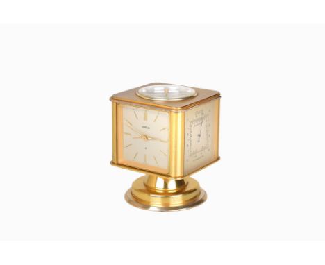 A 20th century Art Deco swivel clock by Angelus. The brass case comprises a clock, a thermometer, compass, hygrometer and bar