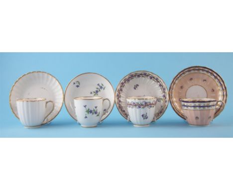Four Derby cups and saucers circa 1790, two painted with cornflowers, one with blue and gilt on a salmon pink ground, three w
