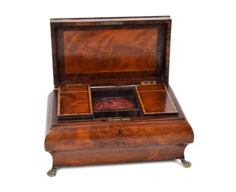 A 19th century sarcophagus rosewood veneered tea caddy. With satinwood inlay and cross-banding and brass lion's feet. The int