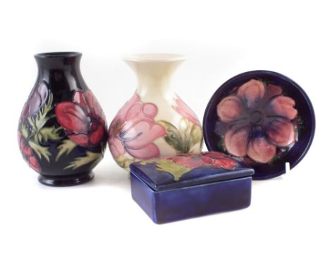 Two Moorcroft vases, small bowl and a box, decorated with Hibiscus, Anemone, and Magnolia, pattern, the Anemone vase has a si