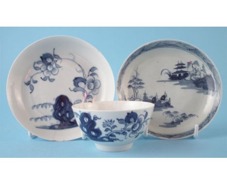 Two Liverpool Chaffers saucers and a tea bowl circa 1760-1765, painted with a Chinese landscape and flora issuing from rockwo