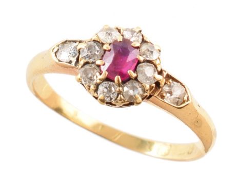 Circa 1900 ruby and diamond round cluster 18ct gold ring with diamond set shoulders , central ruby measuring approx. 4mm x 3m