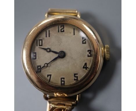 An early 20th century gold plated manual wind watch, the movement signed Rolex, on a 9ct expanding bracelet.