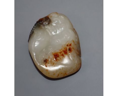 A Chinese white and russet jade carving of a lotus pod