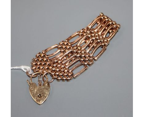A 9ct rose gold flexible gate-link bracelet with padlock clasp, 23.1 grams.