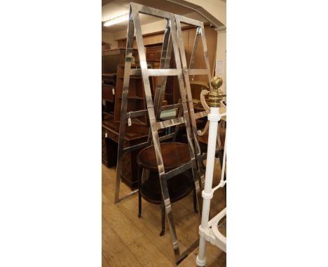 A pair of Zarach chrome shelf stands