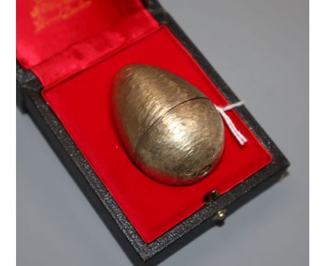 A Stuart Devlin Surprise Egg in silver gilt and enamel, opening to reveal a frog on a lily pad, on stand with original box Lo